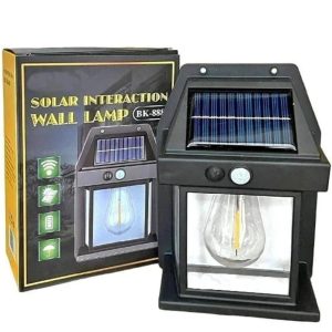Black BK-888 Solar Interaction Wall Lamp displaying its built-in vintage LED filament bulb and top solar panel next to its retail box