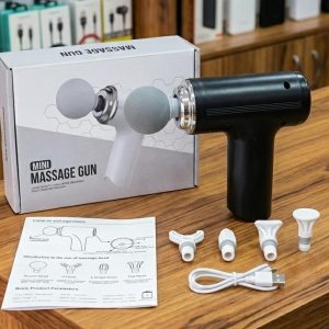 Black Mini Massage Gun displayed with its retail box, 4 white interchangeable massage heads, a USB charging cable, and the user manual